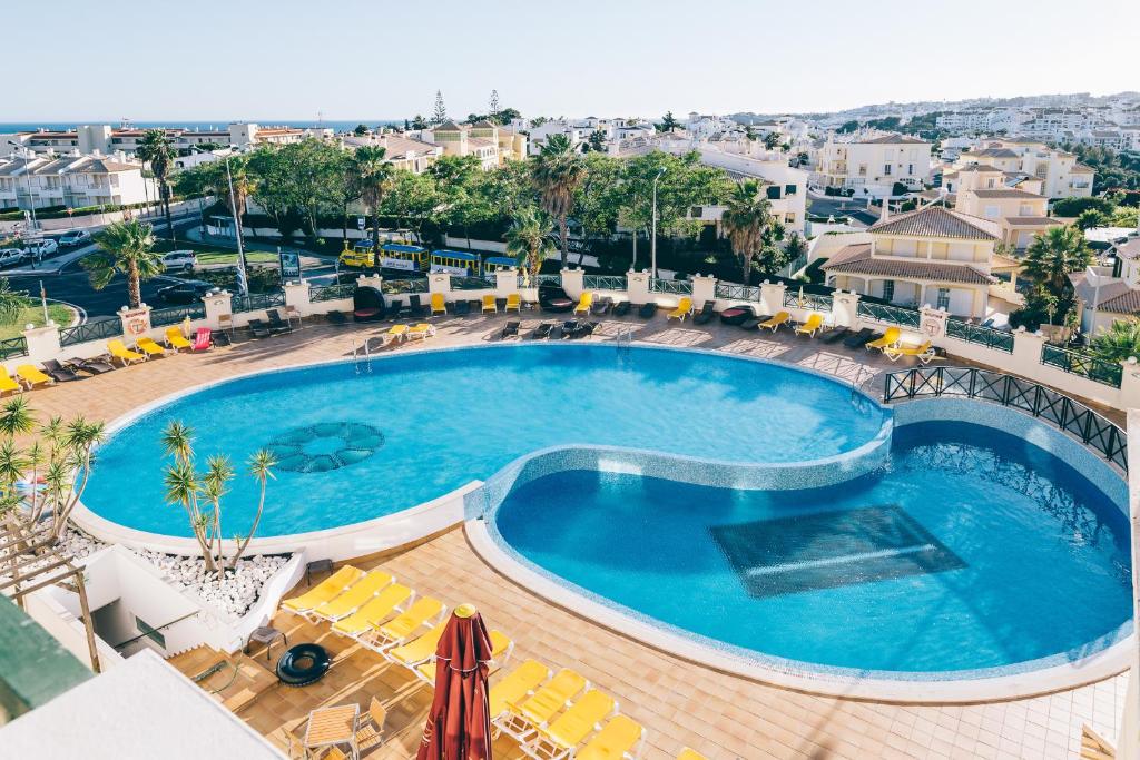 a large swimming pool in a large city at Grand Muthu Forte do Vale in Albufeira