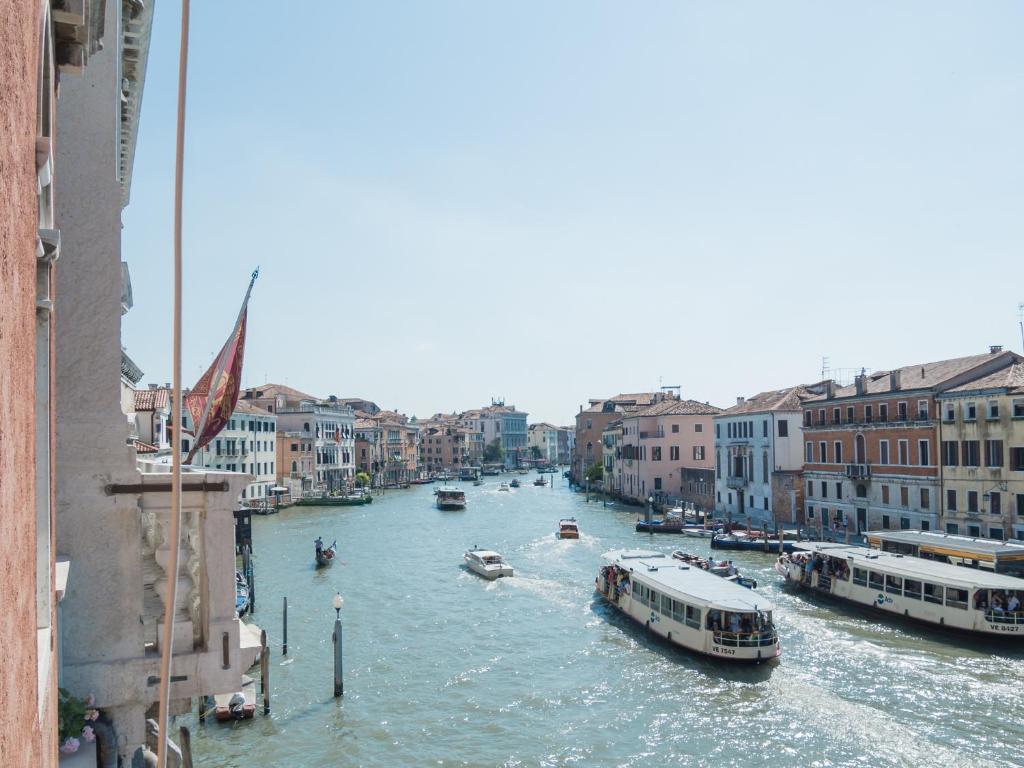 
boats are docked in the water at Luxury Apartment On Grand Canal in Venice
