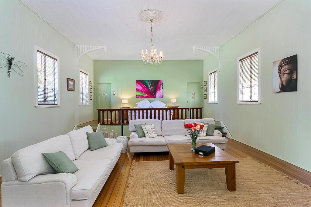 a living room with two couches and a coffee table at The Church in Yungaburra