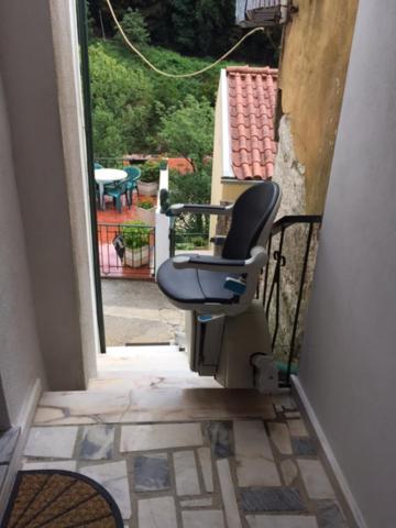 a chair sitting on the balcony of a house at Casa da Avó in Geres