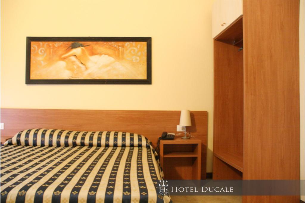 Postel nebo postele na pokoji v ubytování Hotel Ducale
