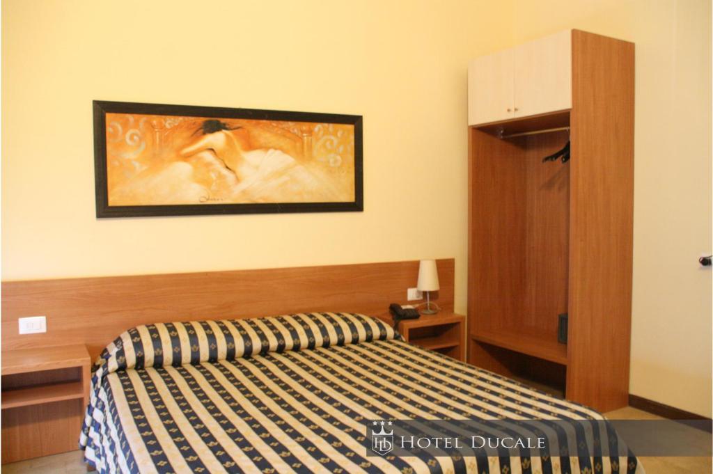 Postel nebo postele na pokoji v ubytování Hotel Ducale