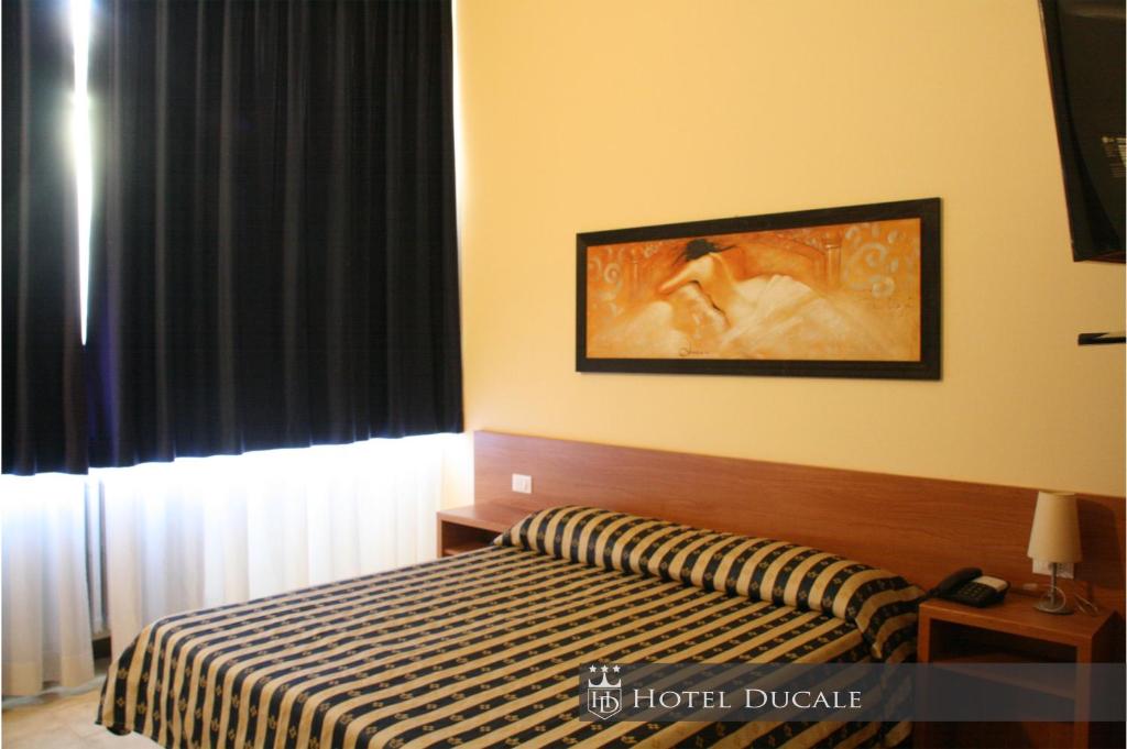 Postel nebo postele na pokoji v ubytování Hotel Ducale