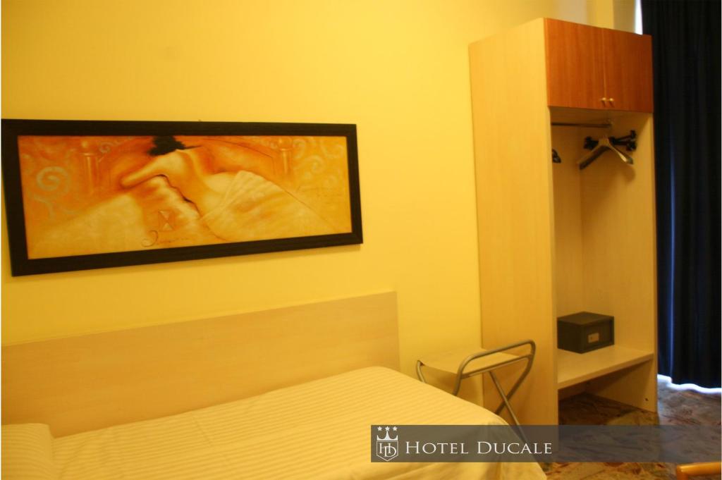 Postel nebo postele na pokoji v ubytování Hotel Ducale