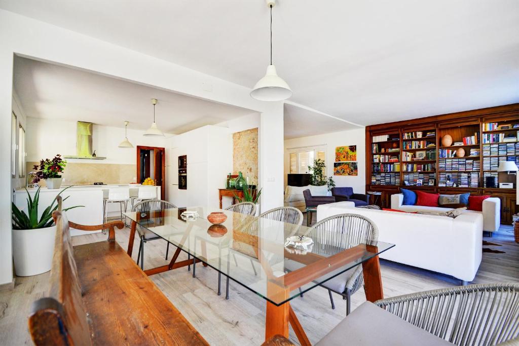 a living room with a table and chairs at VILLA ES TORRENTÓ (HIGH FLYER) in Palma de Mallorca