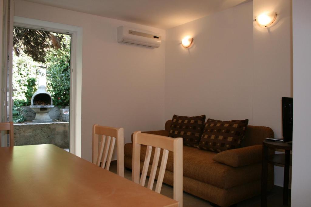 a living room with a table and a couch at Apartments Mrduljaš in Split