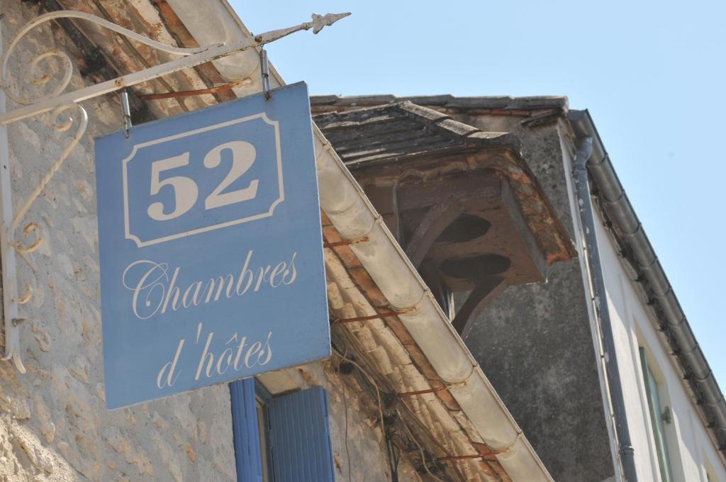 a blue sign on the side of a building at 52 Eymet in Eymet