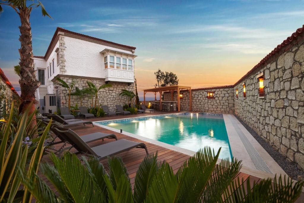 a swimming pool in the backyard of a house at Eritrina Alacati in Alacati