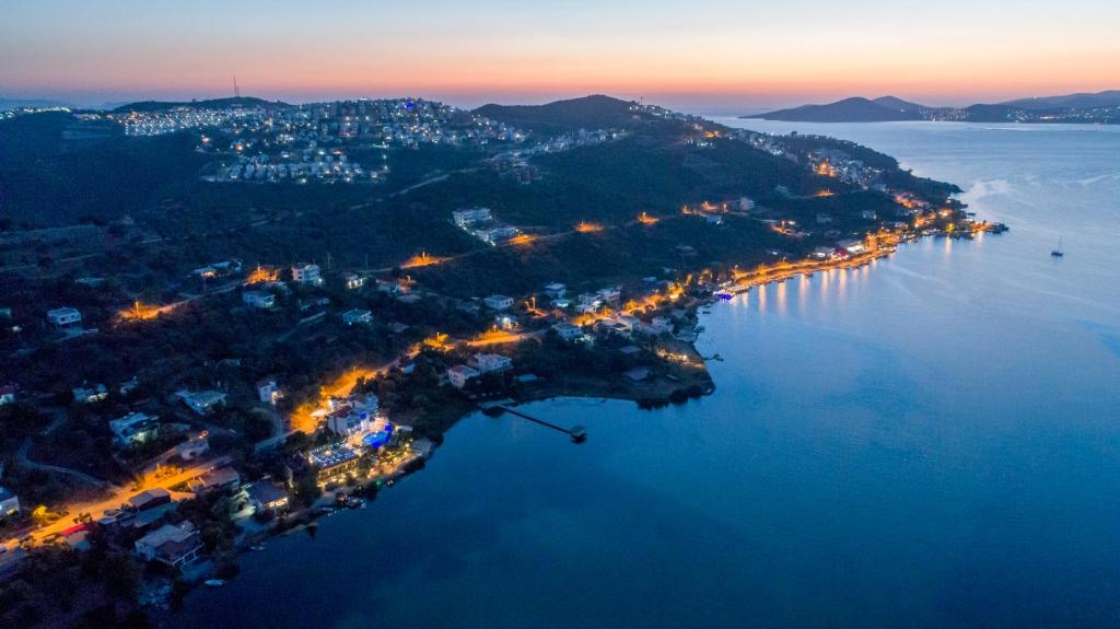 an aerial view of an island in the water at night at Yalicapkini Boutique Hotel in Gulluk