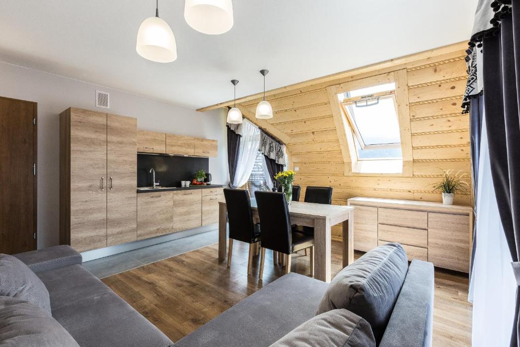 Televízia a/alebo spoločenská miestnosť v ubytovaní Giewont Residence