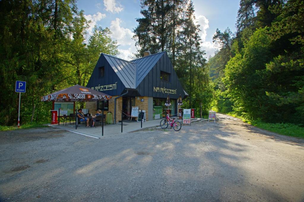 a building with a roof on the side of a road at Studio Pohoda Na Razcesti Cingov Slovensky Raj in Spišské Tomášovce