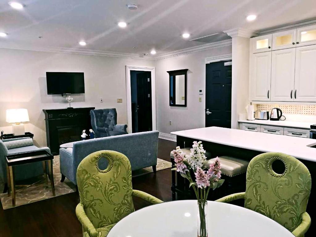 a living room with a couch and a table at Sydney Boutique Inn & Suites in Charlottetown