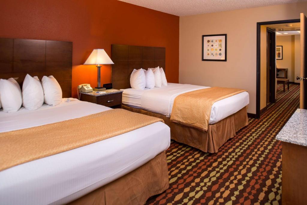 a hotel room with two beds and a phone at Best Western Ambassador Inn & Suites in Wisconsin Dells