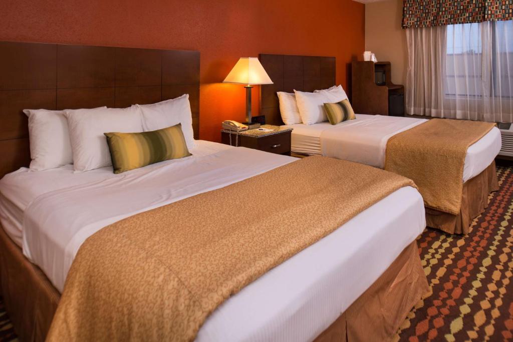a hotel room with two beds in a room at Best Western Ambassador Inn & Suites in Wisconsin Dells
