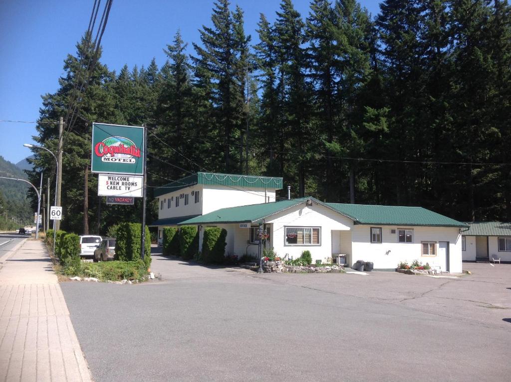 a small white building with a sign in front of it at Coquihalla Motel in Hope