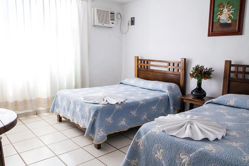Postel nebo postele na pokoji v ubytování Vallartasol Hotel
