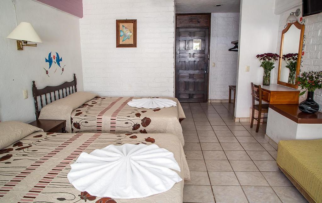 Postel nebo postele na pokoji v ubytování Vallartasol Hotel