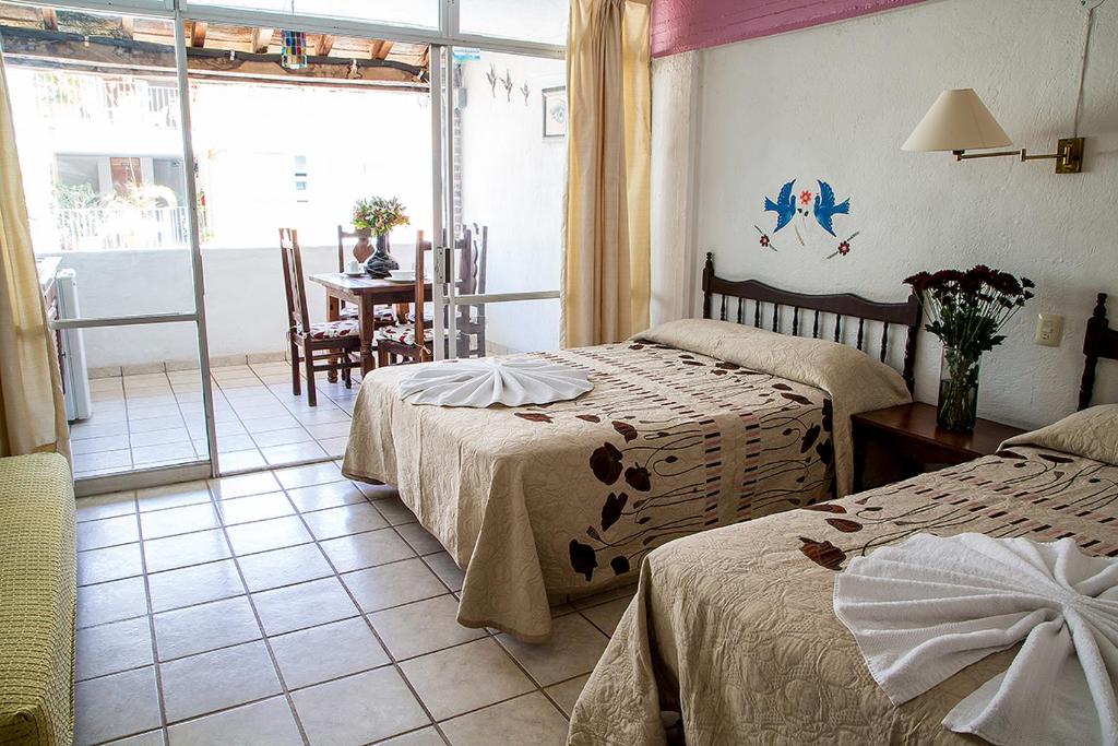Postel nebo postele na pokoji v ubytování Vallartasol Hotel