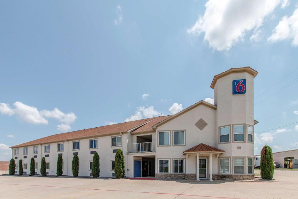 a large white building with a no sign on it at Motel 6-Hutchins, TX in Hutchins