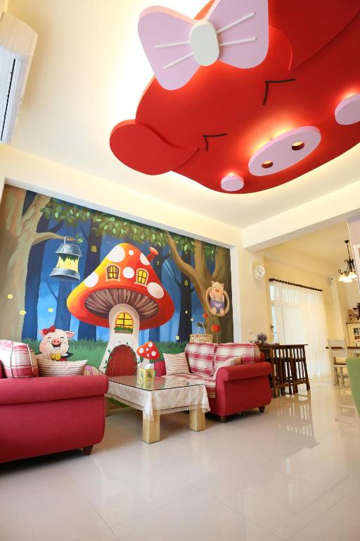 a living room with a large wall mural of a mushroom at Baby Pig B&B in Taitung City