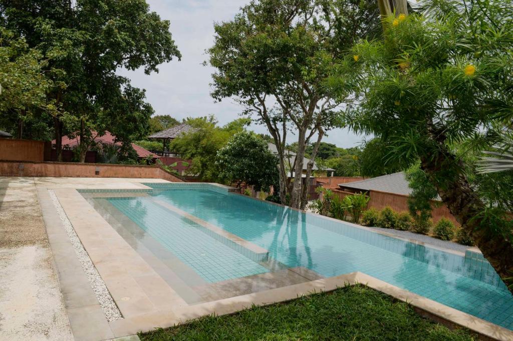 a swimming pool in the yard of a house at Villa Itam in Ko Lanta