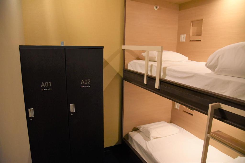 Hotel The Gate Kumamotoにあるベッド