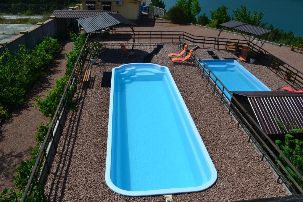 a blue slide in a backyard with two pools at Serebryanoe Ozero in Alushta