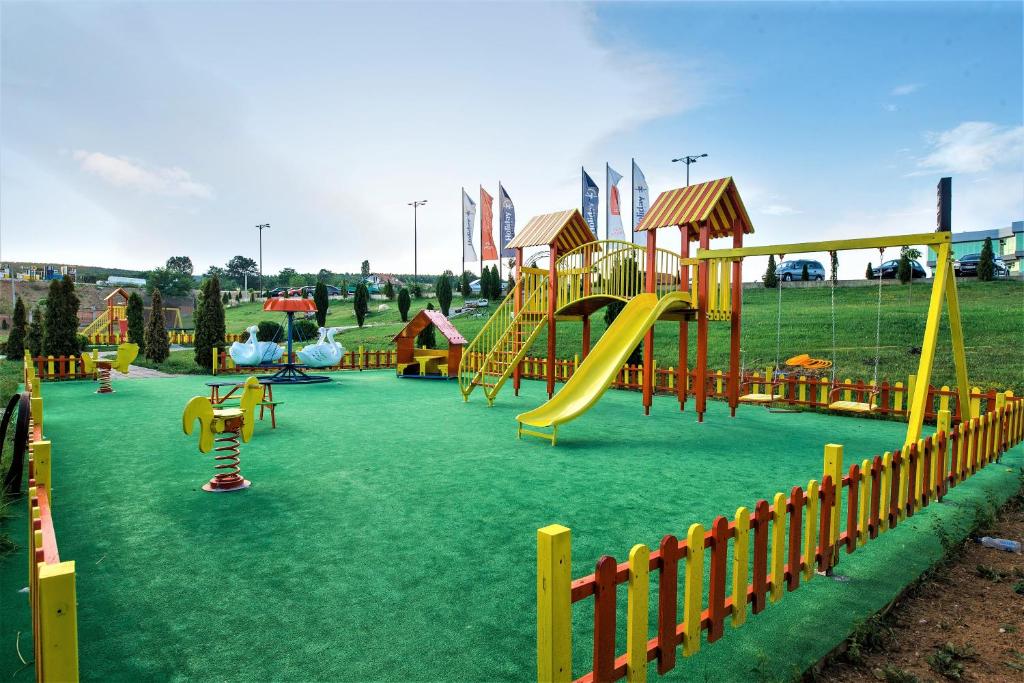 a playground with a slide in a park at Holiday Resort in Velika Slatina