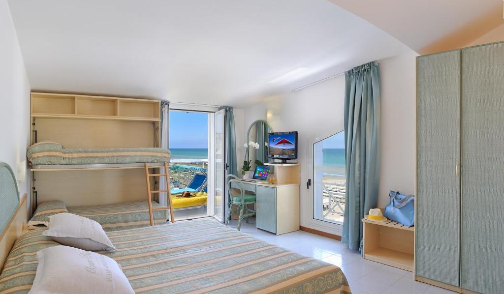 Posteľ alebo postele v izbe v ubytovaní Hotel Cigno D'Oro