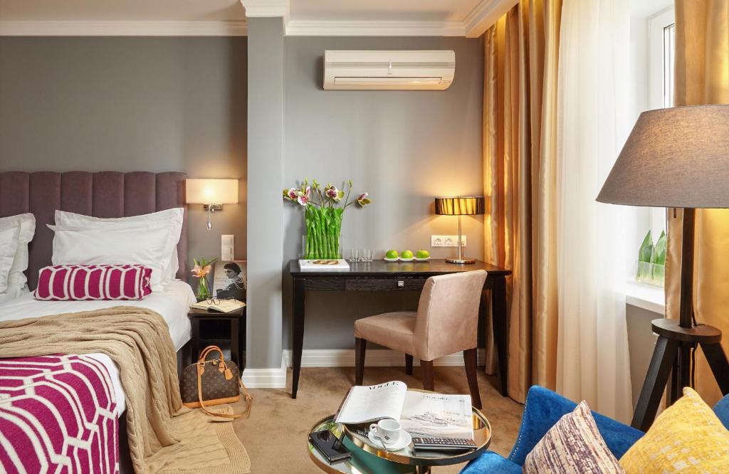a hotel room with a bed and a desk at Easy Room in Nizhny Novgorod