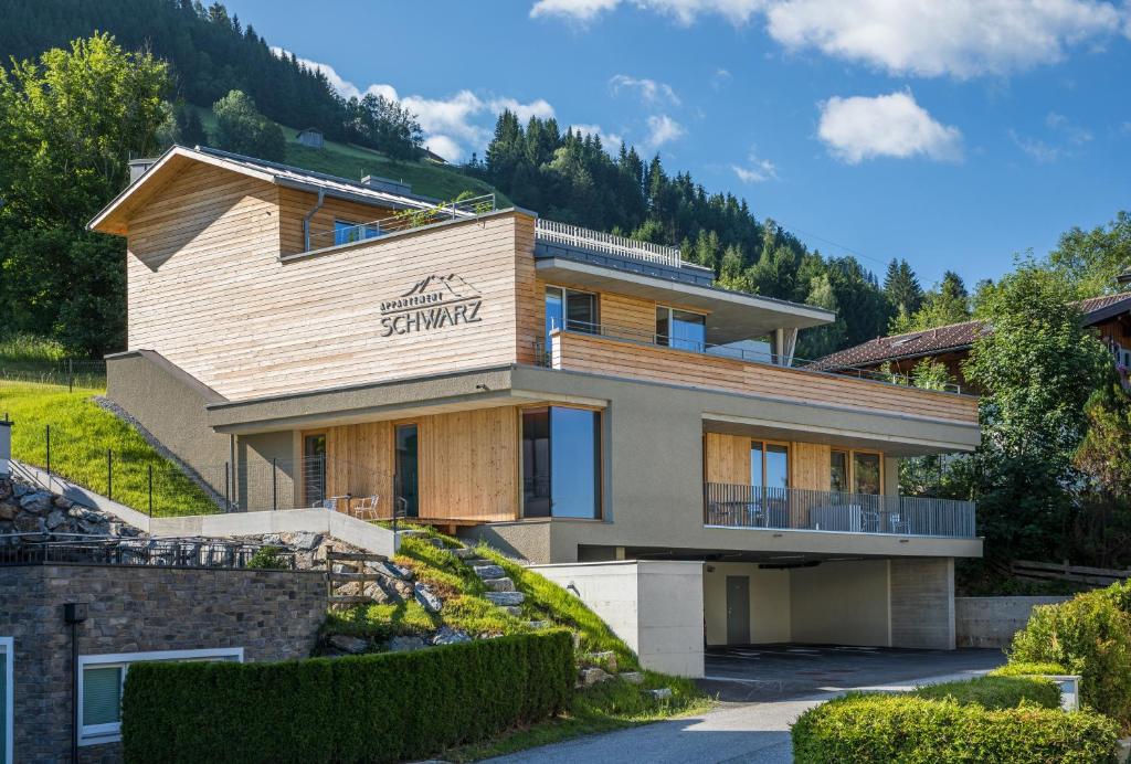 a house on a hill with a mountain at Appartement Schwarz in Sankt Johann im Pongau