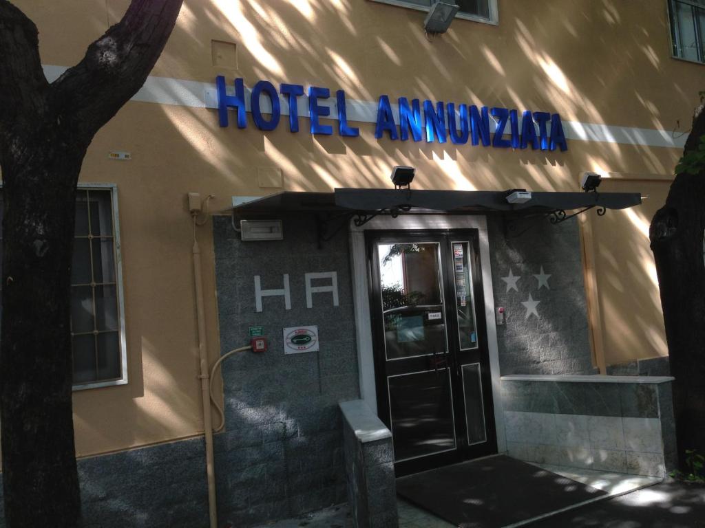 uma entrada do hotel com uma placa no lado de um edifício em Hotel Annunziata em Massa