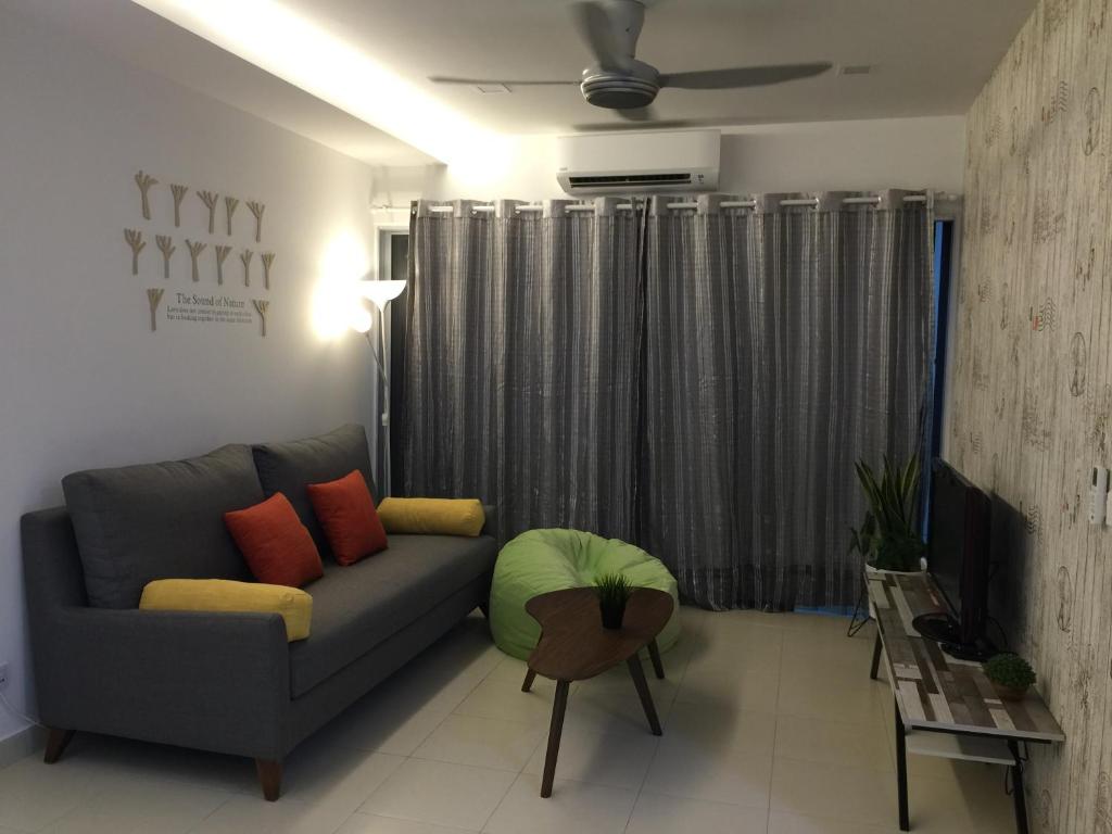 a living room with a couch and a table at Family Friendly Homestay at Setia Alam in Shah Alam