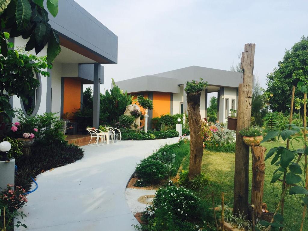 a house with a walkway in front of it at Ok Farm Resort in Det Udom