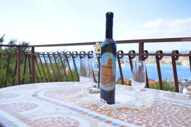 a bottle of wine sitting on a table with a glass at Apartman 1 in Podstrana