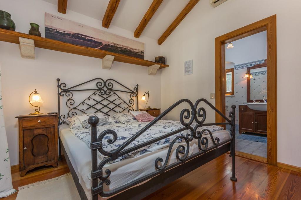 a bedroom with a bed and a mirror at Guesthouse Casa Nova in Poreč