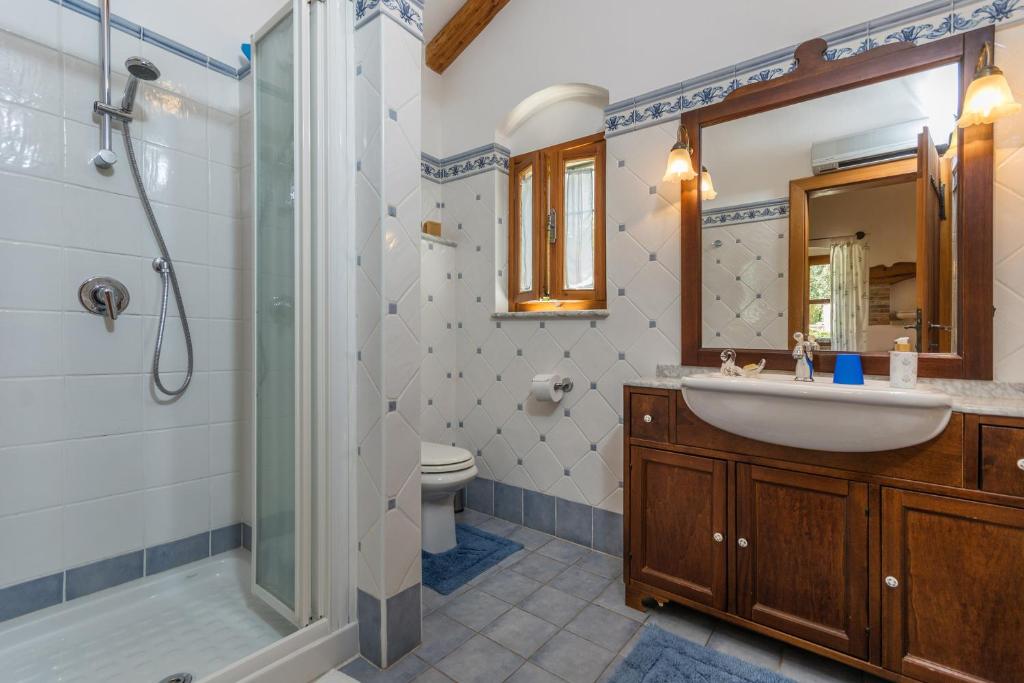 a bathroom with a sink and a shower and a toilet at Guesthouse Casa Nova in Poreč