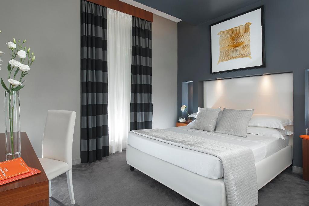 Postel nebo postele na pokoji v ubytování Metropolis - Hotel di Charme