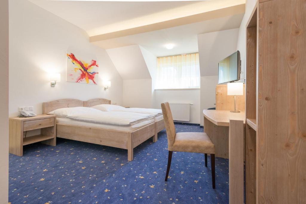Postel nebo postele na pokoji v ubytování Hotel Vösenhuber