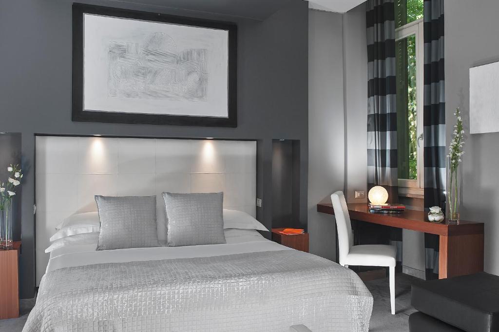 Postel nebo postele na pokoji v ubytování Metropolis - Hotel di Charme