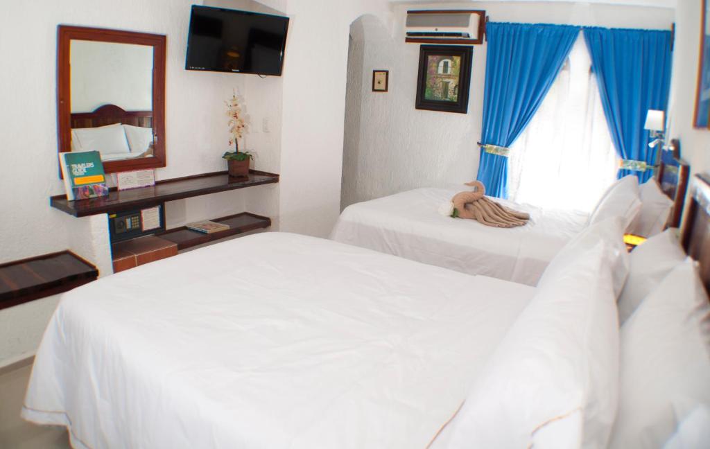 Cama ou camas em um quarto em Eco-hotel El Rey del Caribe