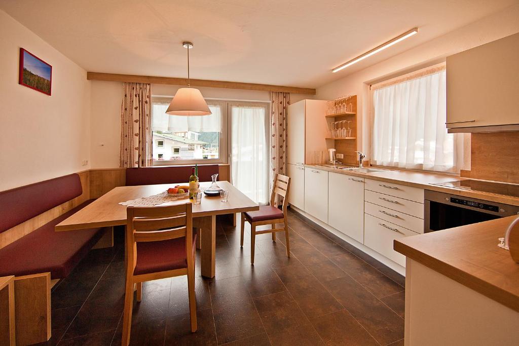 a kitchen with a table and chairs in a room at Haus St. Christoph in Mayrhofen