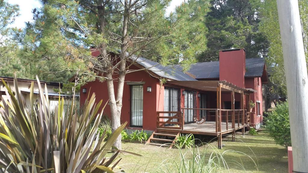 Casa roja con porche y terraza en La Gringa, un espacio único en medio del bosque en Mar de les Pampas