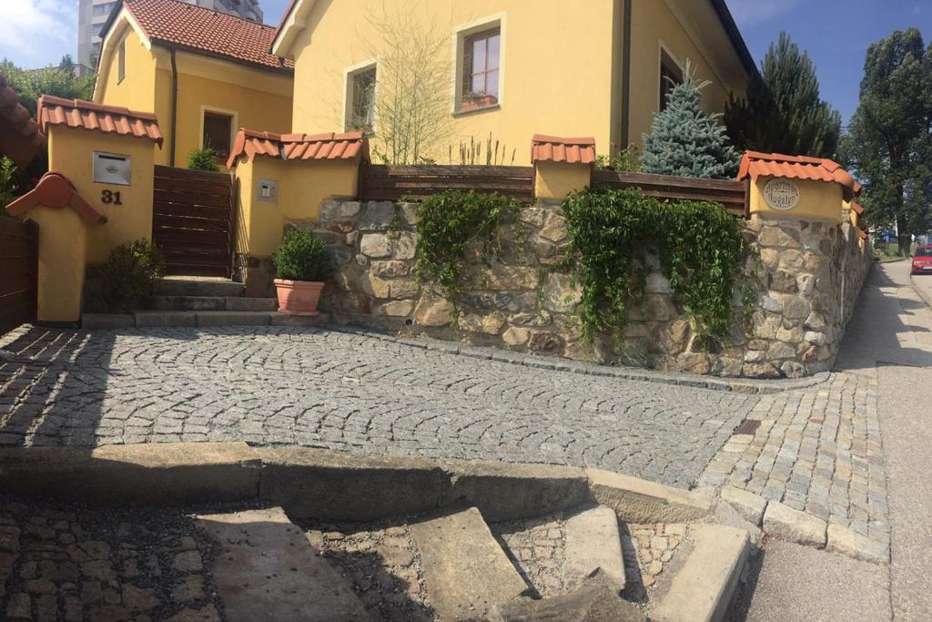 una casa con un camino de piedra frente a un edificio en Apartmán Augsten, en Český Krumlov