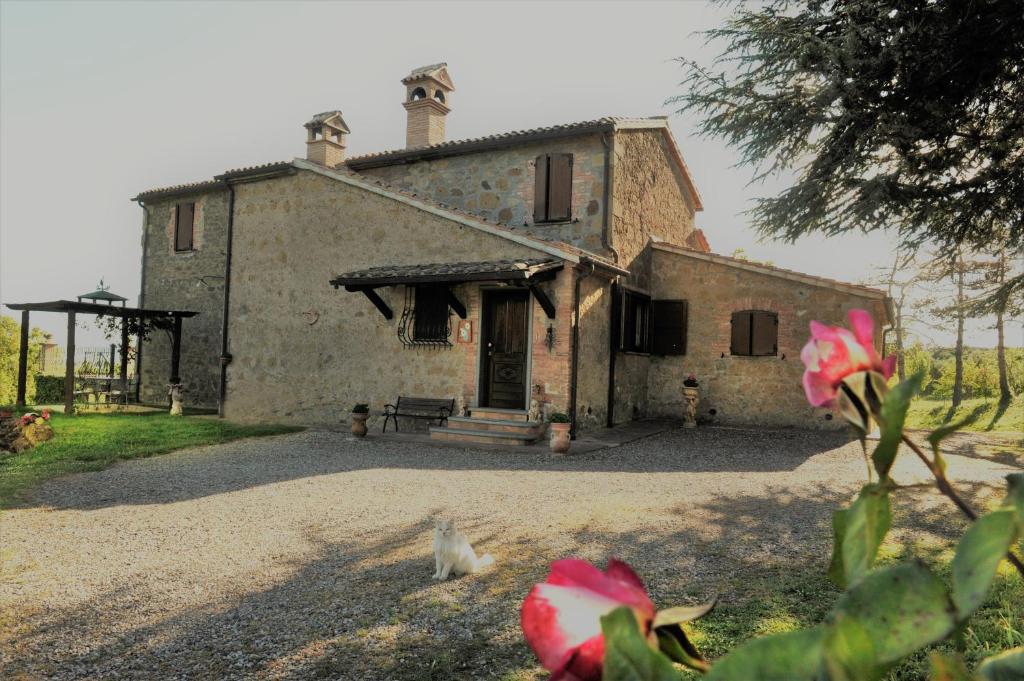 an old stone house with a bench in front of it at Casa Vacanze Paradiso in San Lorenzo Nuovo