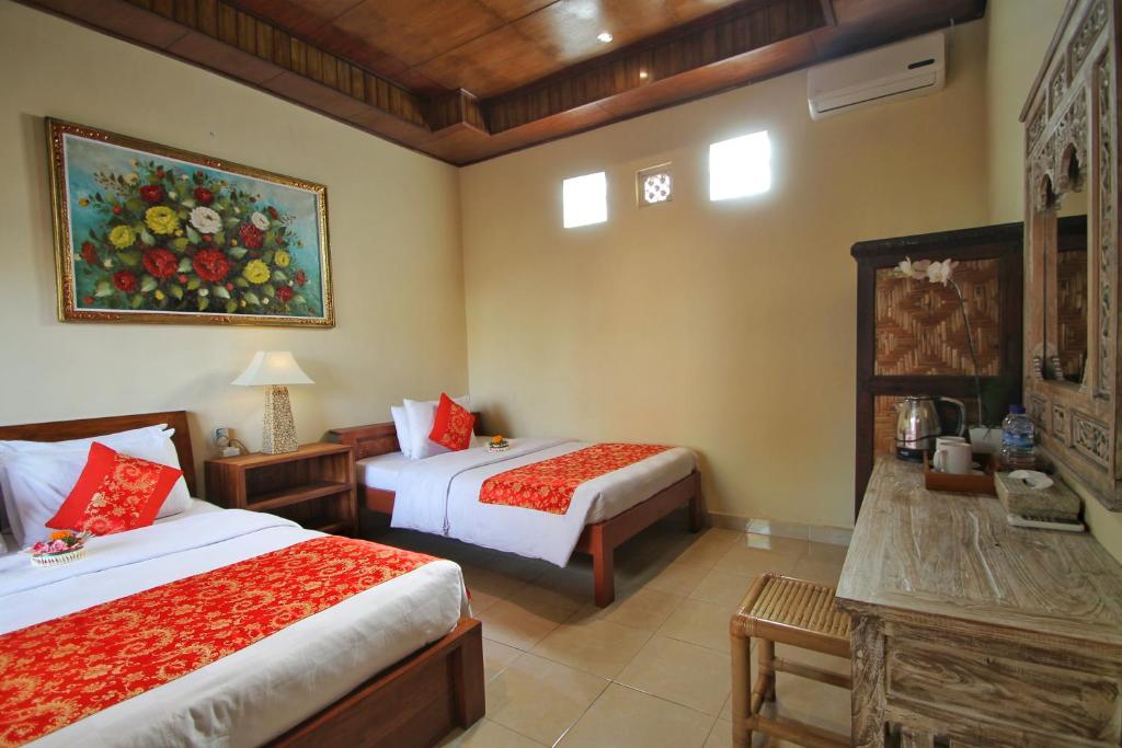 Postel nebo postele na pokoji v ubytování Narada House Ubud