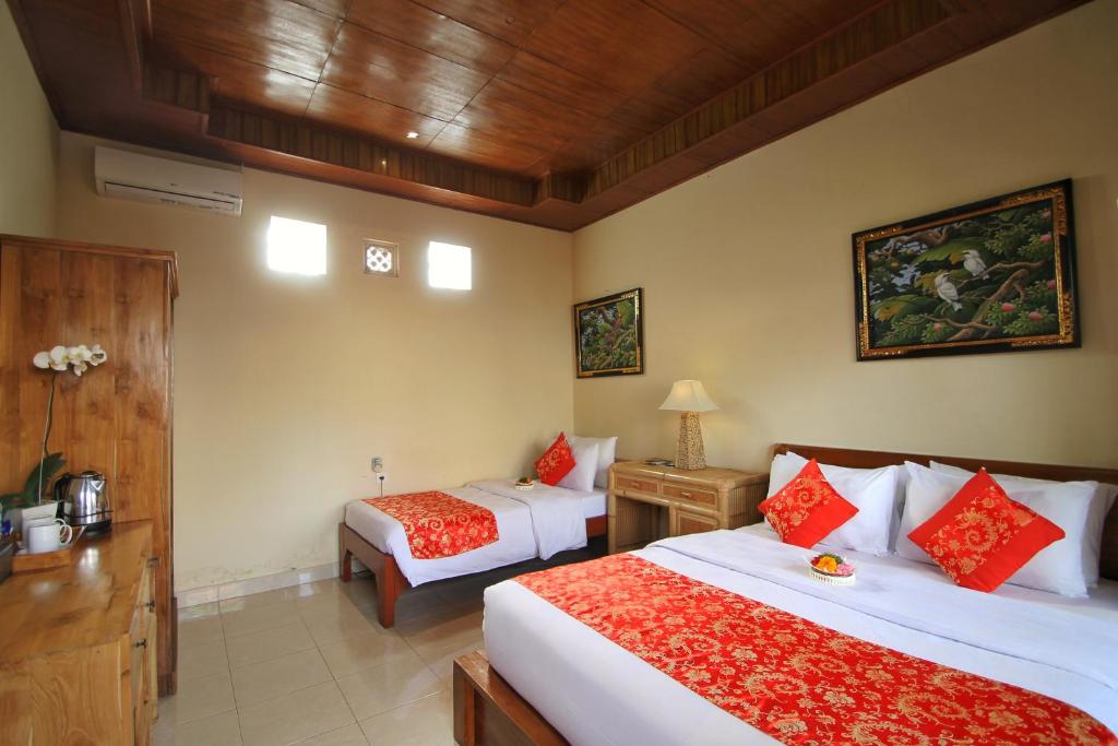 Postel nebo postele na pokoji v ubytování Narada House Ubud