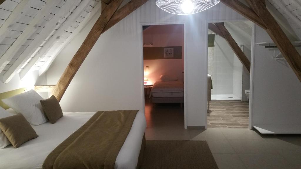 聖阿芒萊索的住宿－La Cense Pierrot des Princes，一间带大床的卧室和一间带床的平方米的房间