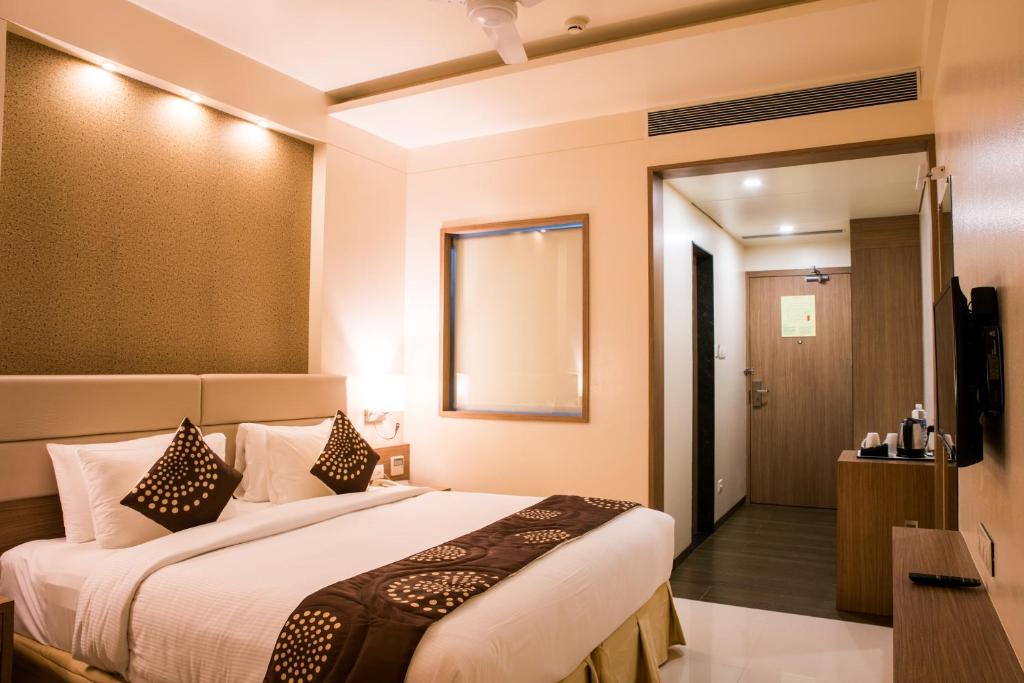 Postel nebo postele na pokoji v ubytování Hotel Grand Rio