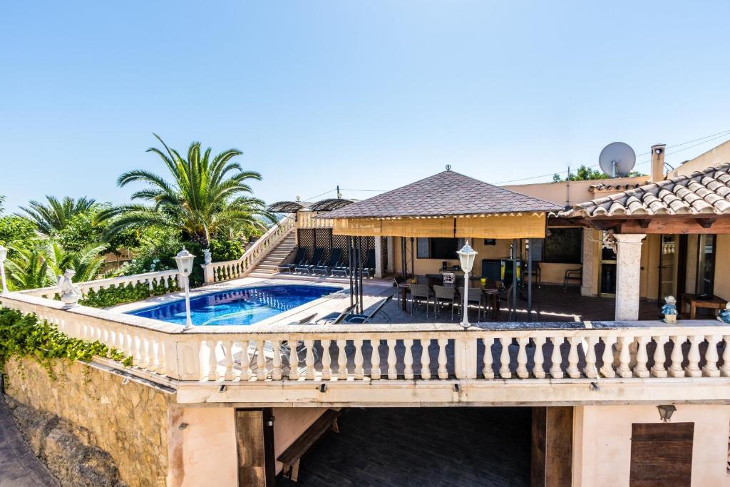 a house with a bridge over a swimming pool at Villa Marina in Playa de Palma in Palma de Mallorca